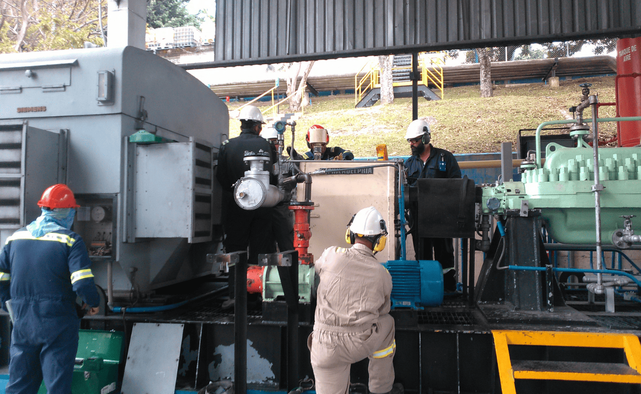 OBS operators performing maintenance on a pumping unit